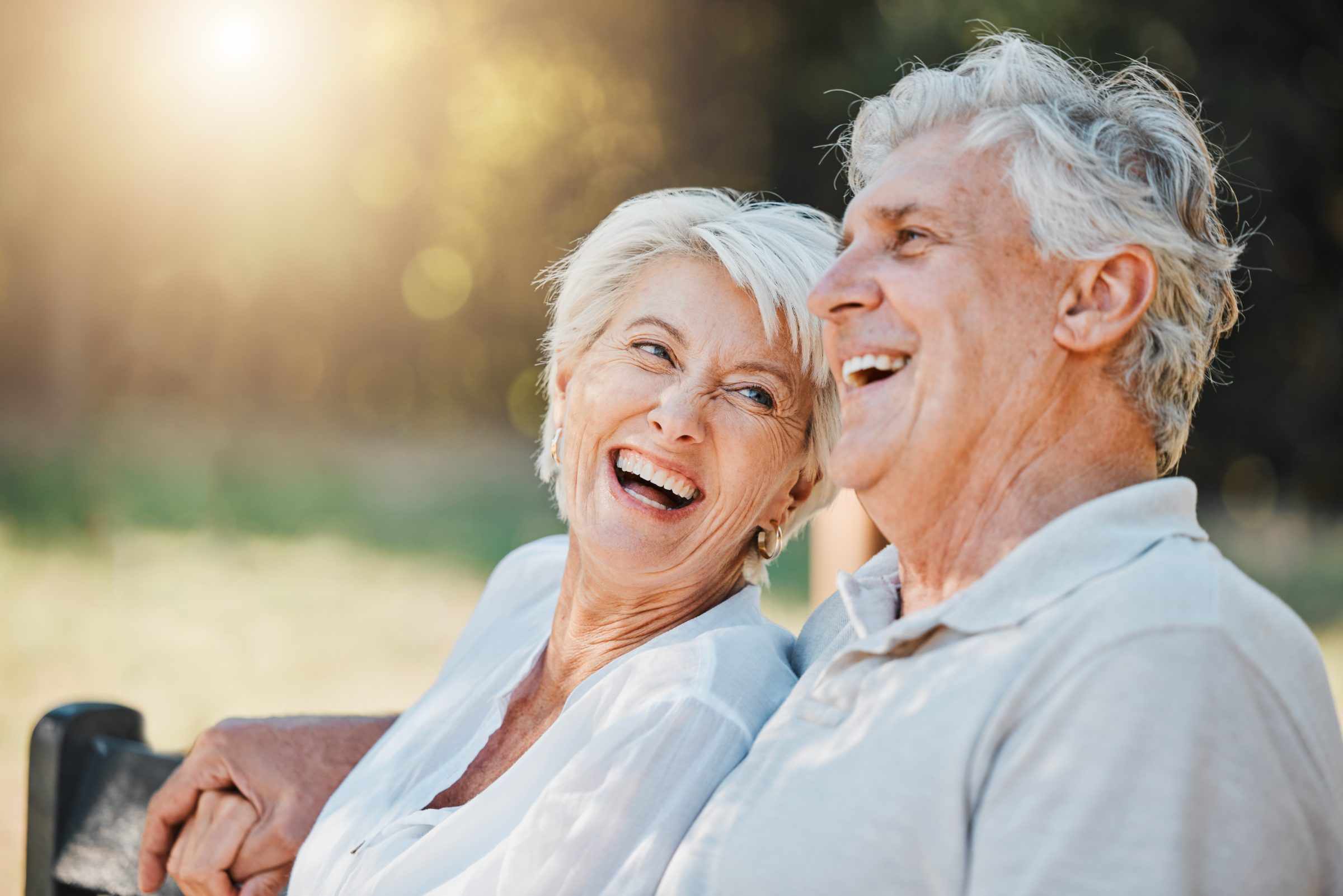 An older couple laughing together outdoors